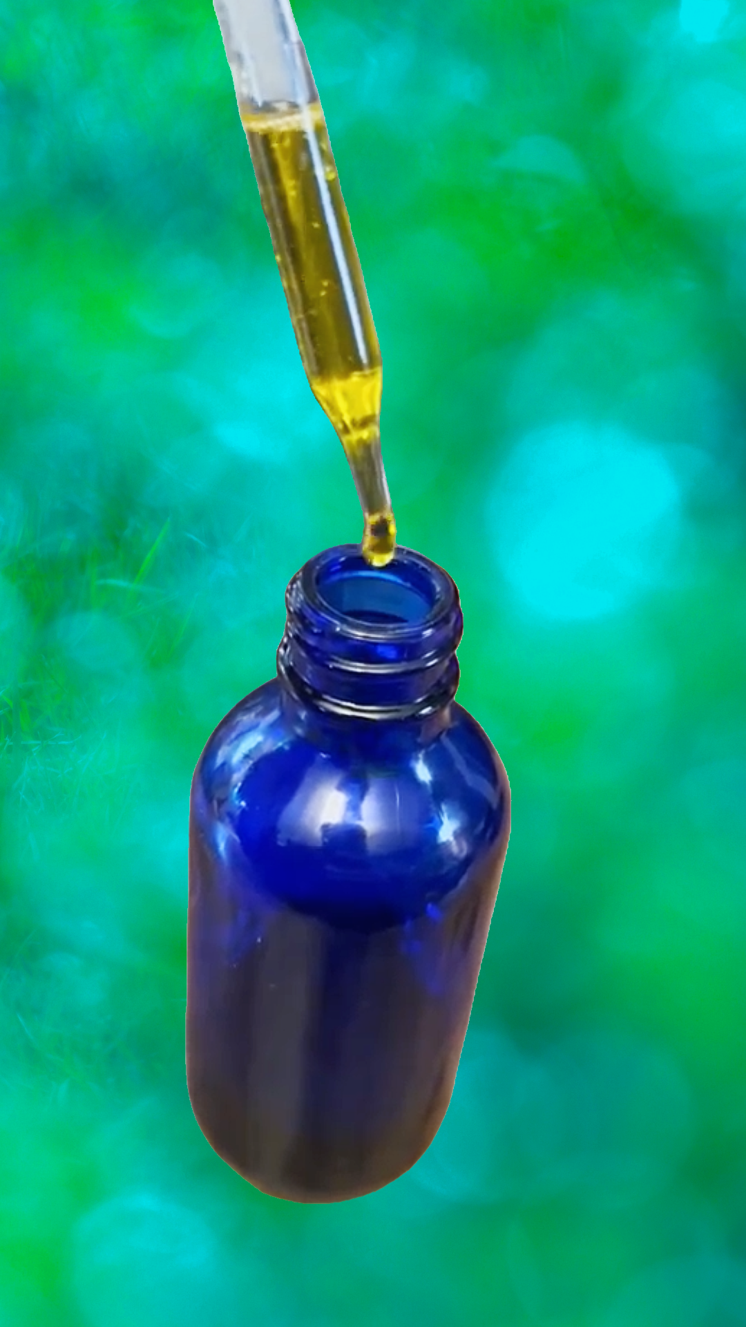 Blue glass bottle with dropper against a green blurred background