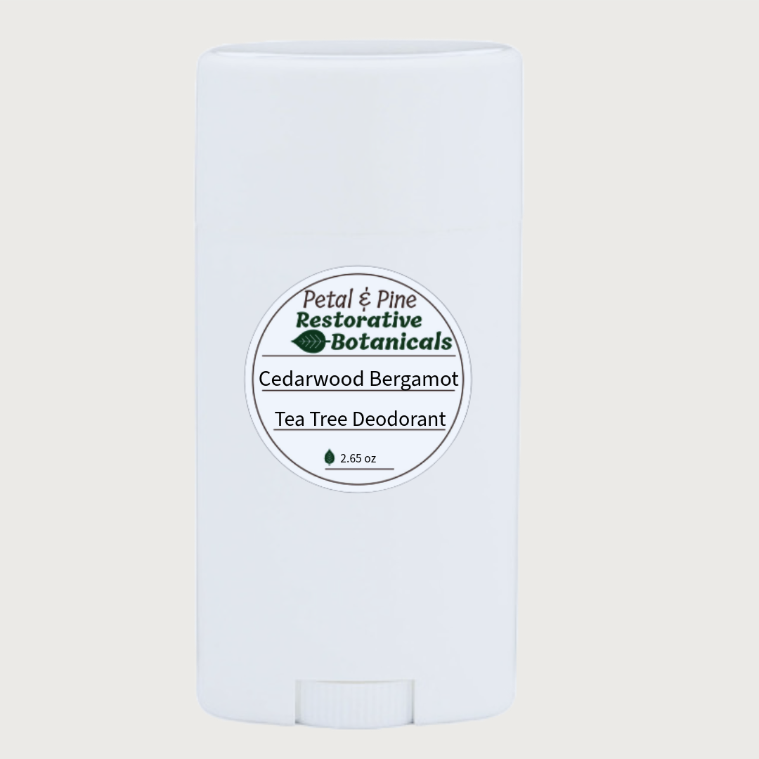 Tea Tree, Cedarwood, Bergamot All Natural Deodorant with a Petal & Pine Restorative Botanical Sticker on a light beige background