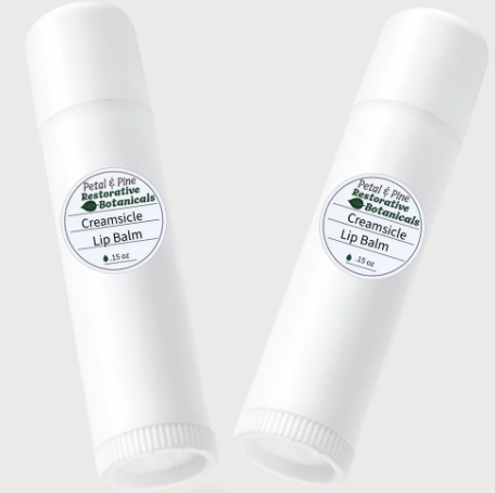 Two tubes of Creamsicle lip balm with labels on a white background