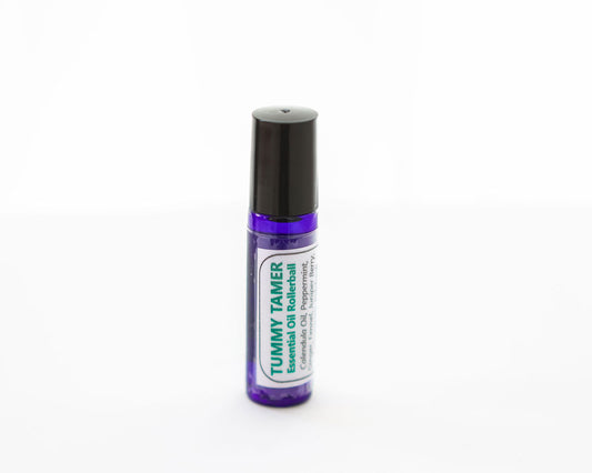 Essential oil rollerball labeled 'Tummy Tamer' on a white background