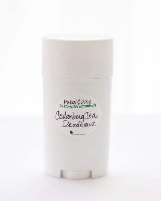 "Cedarberg Tea" is the name of the Tea Tree, Cedarwood, Bergamot All Natural Deodorant with a Petal & Pine Restorative Botanical Sticker on a light beige background