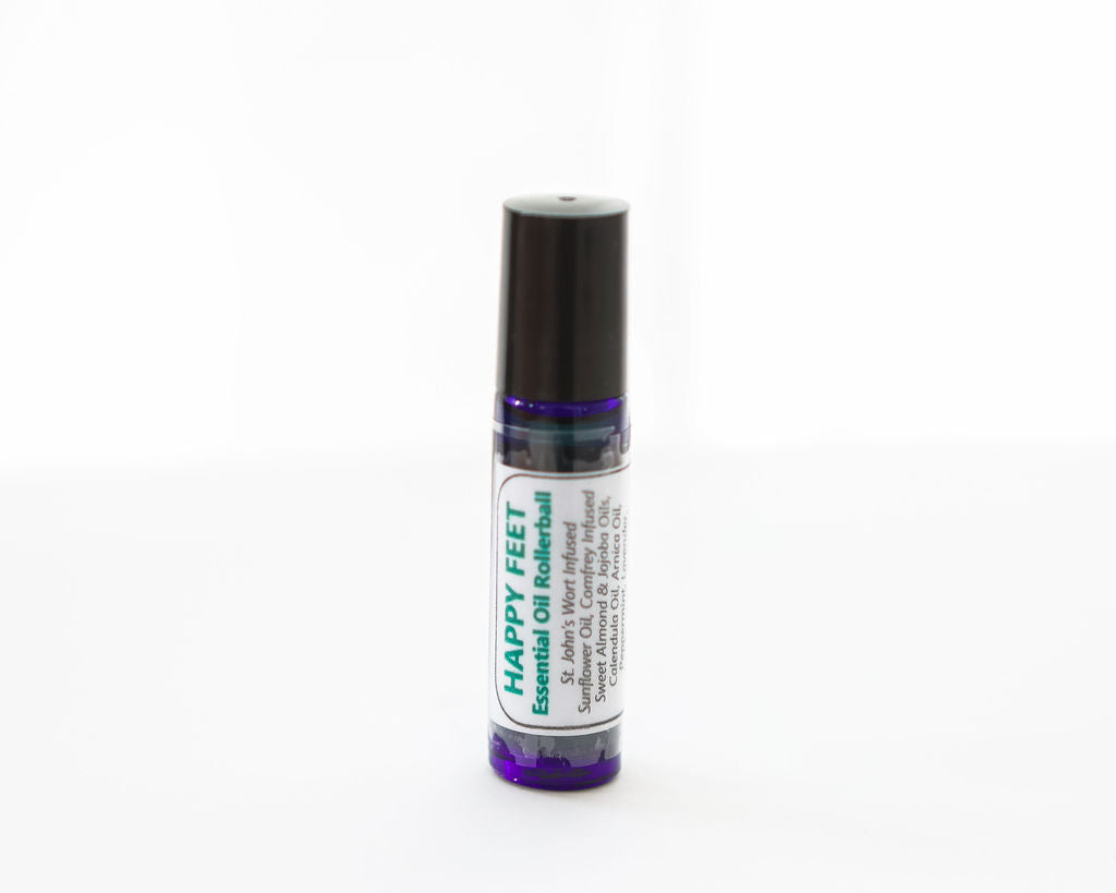 Rollerball labeled 'Happy Feet Essential Oil' on a white background