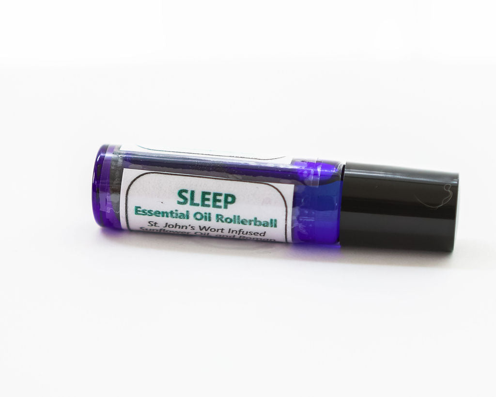 Sleep essential oil rollerball with purple cap on a white background