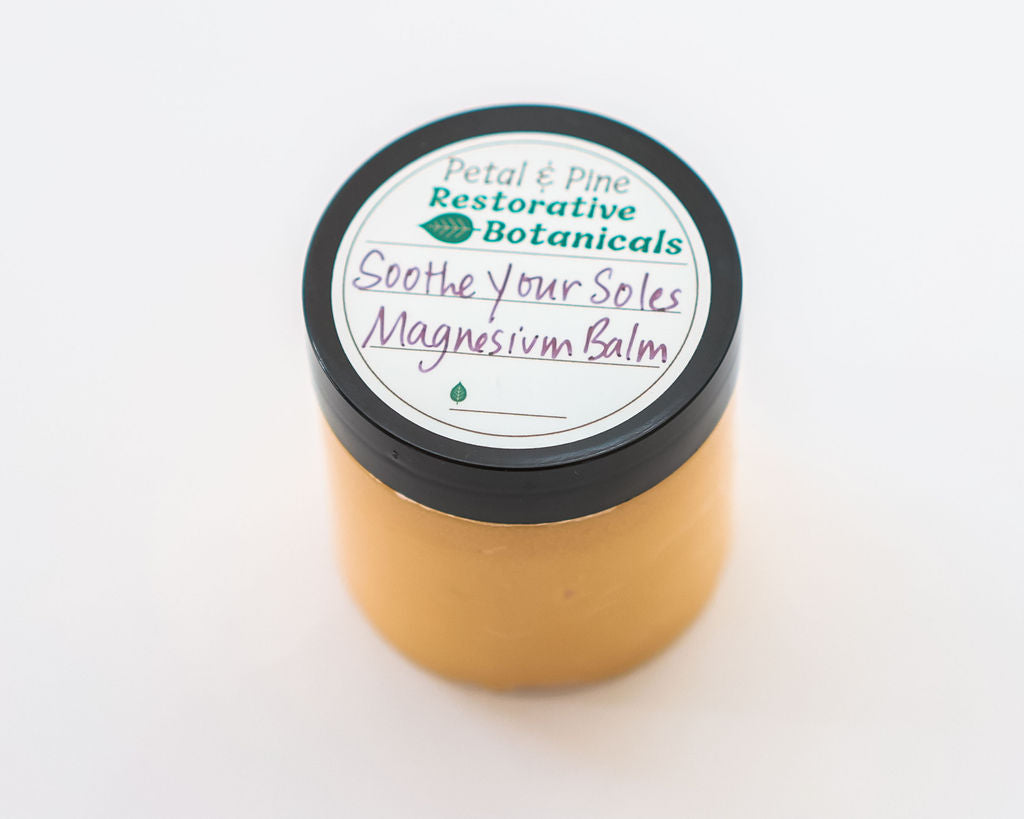 Jar of magnesium balm with a label on a white background